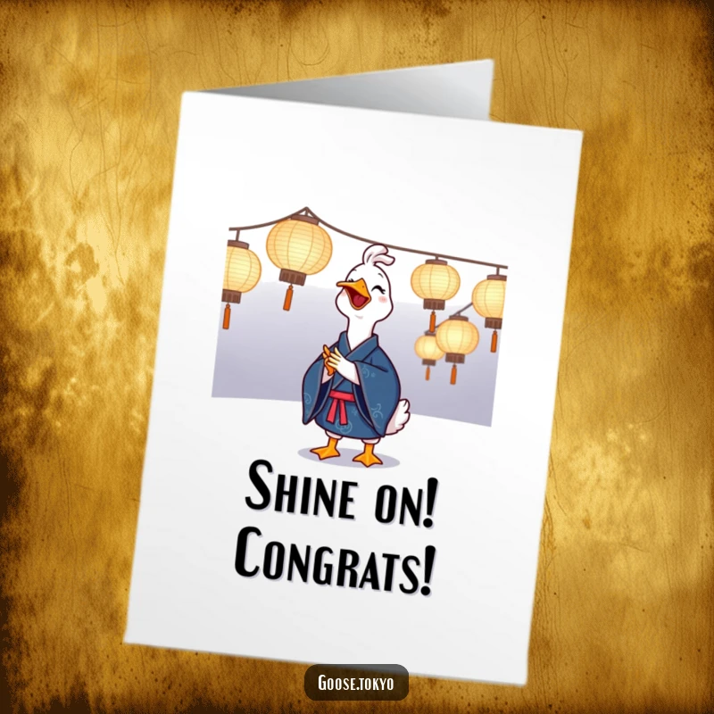 Funny Free Printable Congratulations Card: A happy goose in a kimono clapping enthusiastically by glowing paper lanterns, marking a celebration.