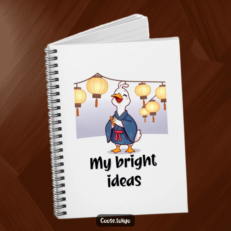 Funny goose notebook with a joyful goose in a blue kimono clapping near illuminated paper lanterns, perfect for journaling festive thoughts.
