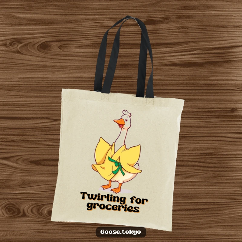 Funny goose tote bag, a happy goose in a flowing yellow kimono joyfully twirling, perfect for shopping or daily use with a smile.